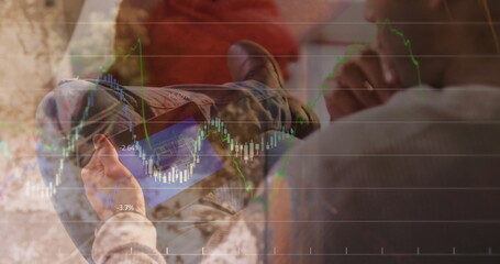Asian man analyzing stock charts on tablet sitting on sofa in living room, with cushion, blanket