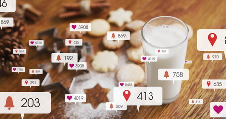 Showing tall glass of milk standing on kitchen table with star cookies, floating icons, copy space