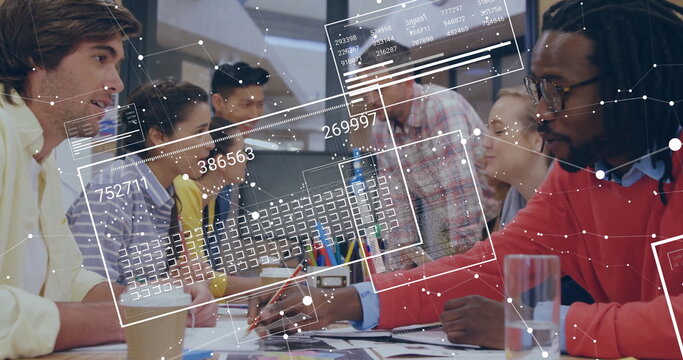 Reviewing analytics team of eight leaning over conference table in open-plan office, with tablet