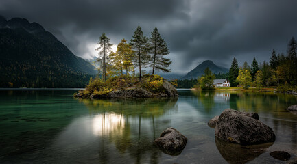 Naklejka premium A beautiful lake with a small island in the middle, trees atop the rocks.