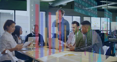 Six professionals collaborating around conference table in office, with laptops, reports and charts