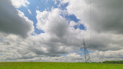 High voltage power transmission tower and electricity pylon with wires against blue sky. Power pole.