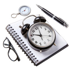A spiral-bound notebook, a vintage alarm clock, a pen, and a small gauge sit atop the pages