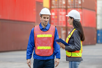 Logistics Team Discussing Cargo Operations at Shipping Port, Female Supervisor and Male Worker Reviewing Shipment Details at Container Yard