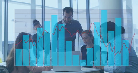 Team members in suits analyzing data on laptop in conference room, with digital graphs overlay