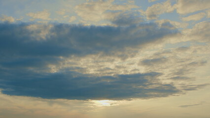 A Beautiful and Cloudy Sunset Casts Its Glow Over a Tranquil and Peaceful Horizon