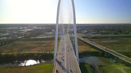Modern Margaret Hunt Hill Bridge and USA flag over Trinity river in Dallas, Texas on a sunny day