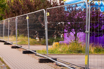 Temporary metal fence on a sidewalk
