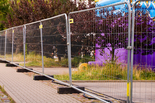 Temporary metal fence on a sidewalk