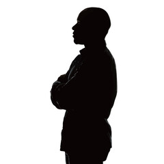 A person stands with arms crossed in a confident pose. The silhouette contrasts sharply with a bright white background, creating a striking visual effect.
