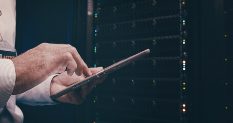 Engineer, hands or man with tablet in server room for security audit, system backup and update....