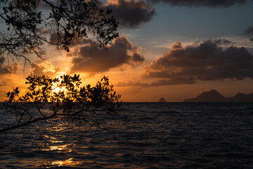 Breathtaking Sunset Over Calm Waters with Silhouetted Mountains in Background