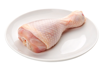 Raw chicken leg quarter with skin on white plate showing natural pink coloring, isolated on a transparent background