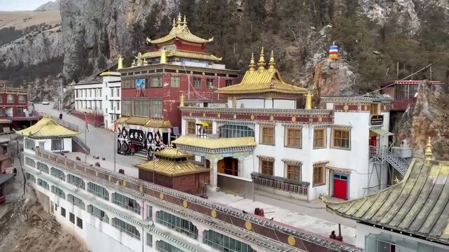 Scenic view of Nangchen Gar Monastery in the historical Amdo region of Tibet, featuring golden rooftops and colorful Tibetan architecture.