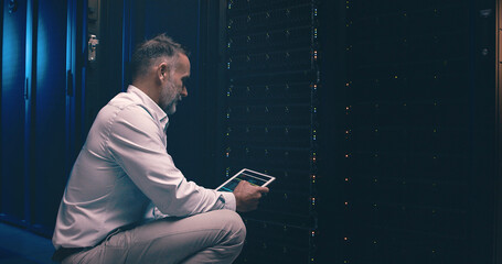 Tablet, developer and technician or man in server room for cyber security, software update and...