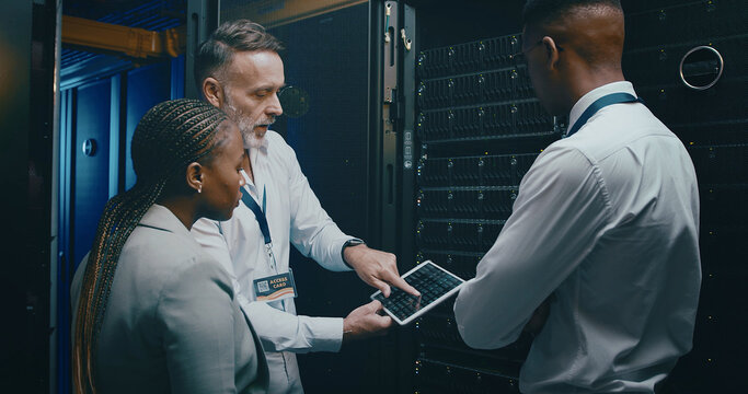 Server room, network and manager with people on tablet for cybersecurity, diagnostics test and maintenance. IT team, meeting and workers with boss for system, online database and technical support