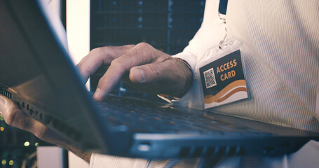 Typing, laptop and hands of man in server room for cybersecurity, network and system database....