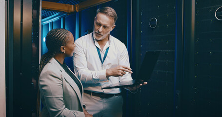 Laptop, team or people in server room for planning, backup or IT training with intern....