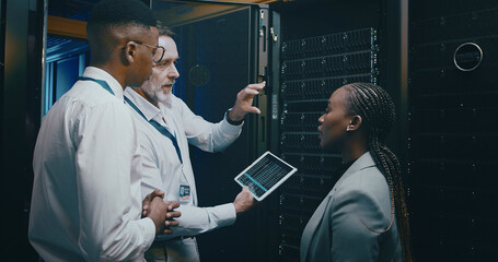 Server room, training and manager with team on tablet for cybersecurity, diagnostics test and maintenance. IT service, meeting and worker with boss for network, online database and technical support