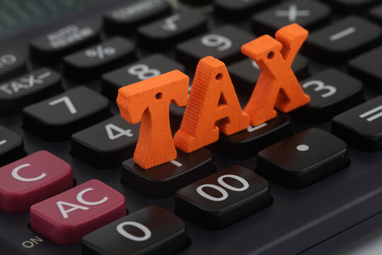 TAX wooden letters on calculator keys