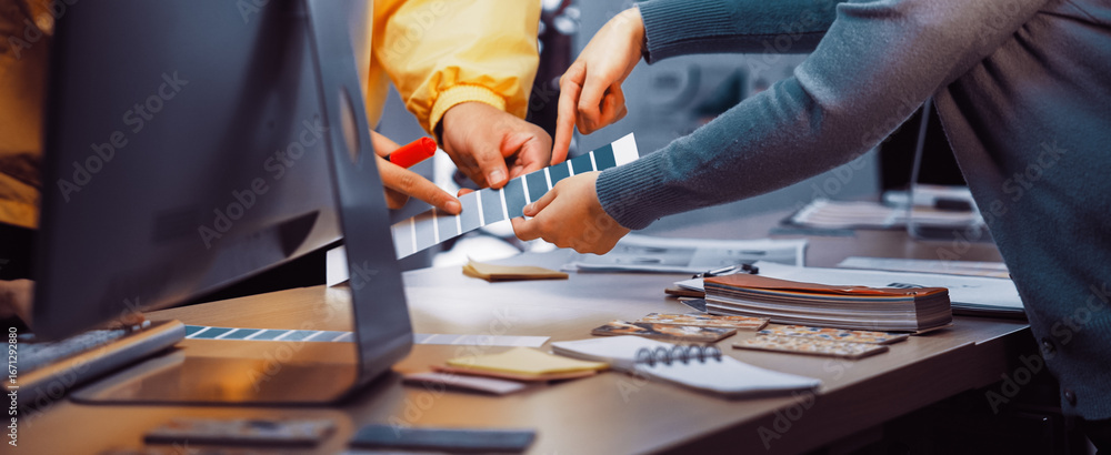 Poster diverse individuals engage in a collaborative color selection process in a modern office space, surr