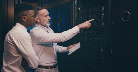 Engineer, people or tablet with inspection in server room for maintenance, backup solution or GDPR. Graphs, team or point to system space for troubleshooting, screen or testing network in data center