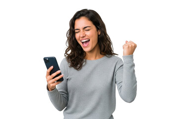 Excited young woman celebrating success while looking at her smartphone, isolated on transparent background
