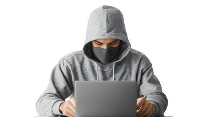 hacker in hoodie and mask that hides his face works at laptop isolated on a transparent background