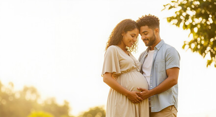 Pregnant african american woman with mixed race partner outdoors in golden light. Diverse maternity session for multicultural family planning services