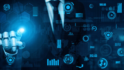 A businessman in a suit uses advanced technology to interact with data visualizations, symbolizing digital transformation and innovative strategies in business management. Xenic