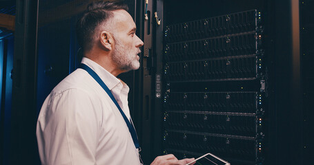 Maintenance, technician and tablet with man in server room for hosting database, inspection and...