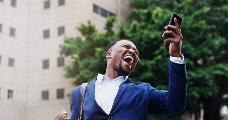 Business, man and celebration with phone in city for good news, bonus and success notification....