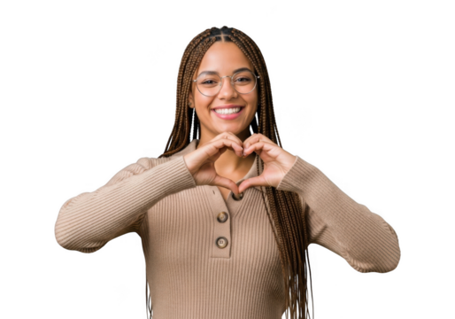 Young woman with braided hair and glasses smiling and making a heart shape with her hands, isolated on transparent background