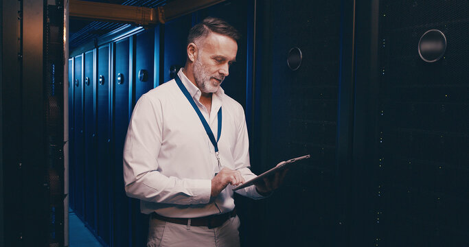 Tablet, reading and technician or man in server room for cyber security, software update and database system. Programmer, developer and cybersecurity with mature person in data center as engineer - Powered by Adobe