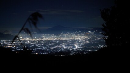 A stunning view of the city lights of Garut at night can be seen from the slopes of Mount...