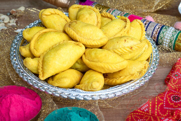 Gujhiya, Indian fried sweet with dry fruits and fancy decorative background