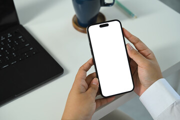 Hands holding smartphone with blank white screen for mobile app or UI mockup presentation