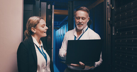 Collaboration, cybersecurity and laptop with people in server room together for network...