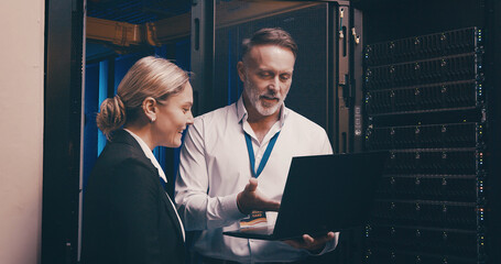 Laptop, talking and team of engineers in server room for technical support, database or cybersecurity. Computer, collaboration and people with system upgrade in data center for network programming.