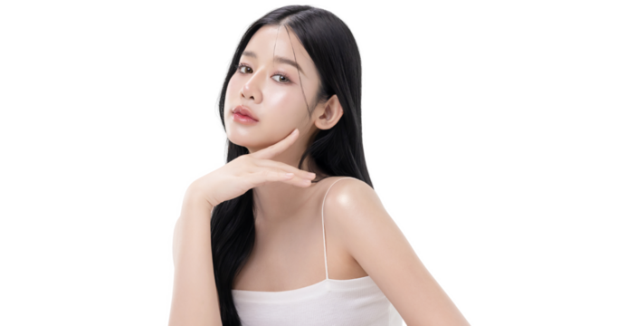 A beautiful Asian woman with long black wavy hair posing gracefully with a soft smile isolated on transparent background, studio beauty portrait. PNG file format.