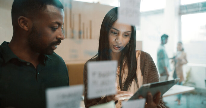 Team, people and brainstorming by glass with tablet for research, sticky note and creative thinking. Info, schedule or vision with employees planning, partner insight and tech for project management
