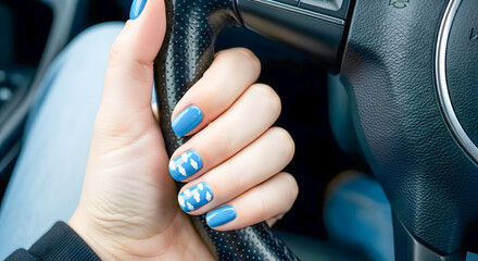 Stylish blue nails with cloud design holding steering wheel, travel concept