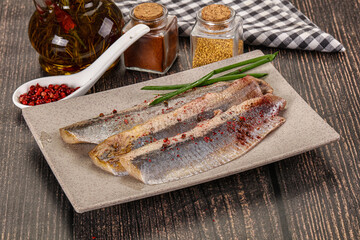 Salted marinated herring fillet with spices