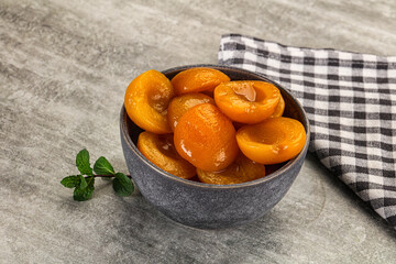 Sweet canned apricots with syrope