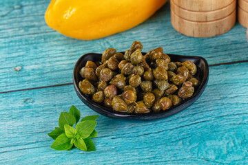 Pickled canned capers in the bowl