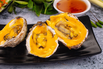 Baked oyster with cheddar cheese