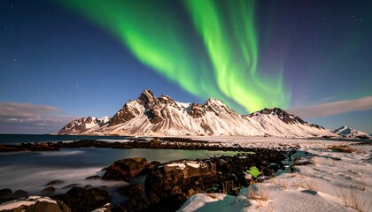 Naklejka premium Northern Lights over Icelandic mountains