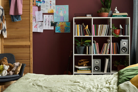 Creative kid room interior with bed and artwork on wall