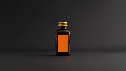 A dark  shot highlights a rectangular brown glass bottle with an orange label.
