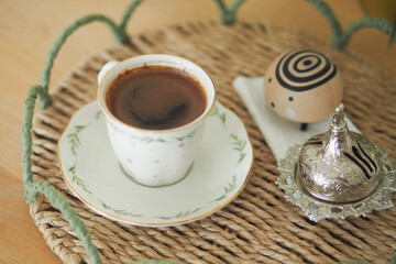 Traditional cup of turkish coffee served on a woven tray